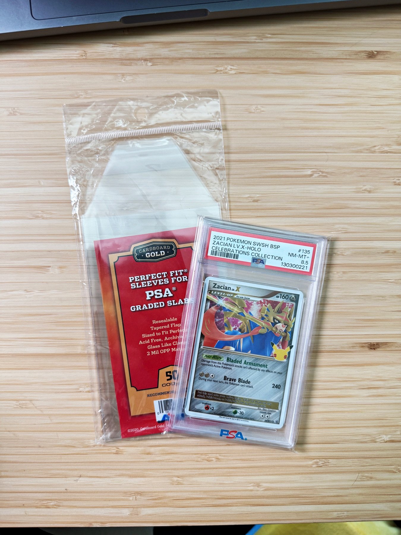 Cardboard Gold protective sleeves fitted over PSA graded card slabs